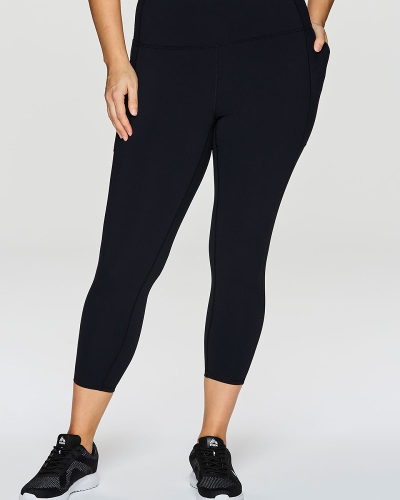 Front of a model wearing a size 1X Highland Super Soft 7/8 Legging in Black by RBX Active. | dia_product_style_image_id:244819